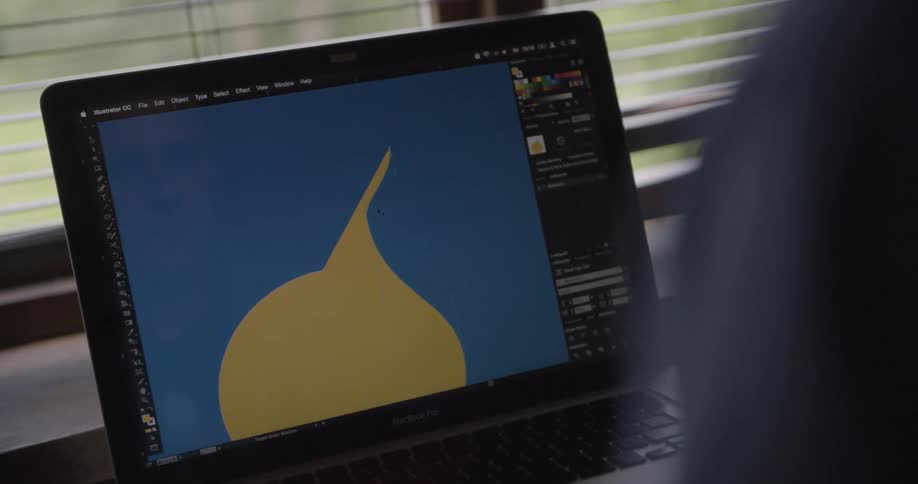 Person works with a digital image on a laptop during the daytime