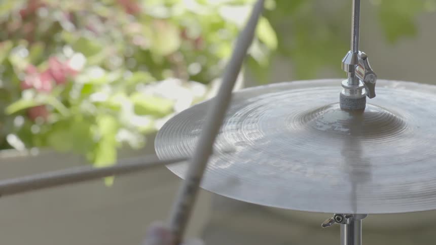 A drummer plays on a hi-hat