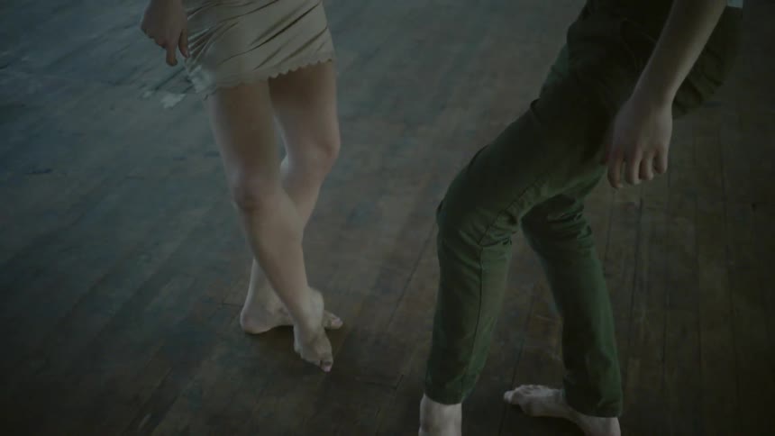 A man and a woman dancing in an abandoned building