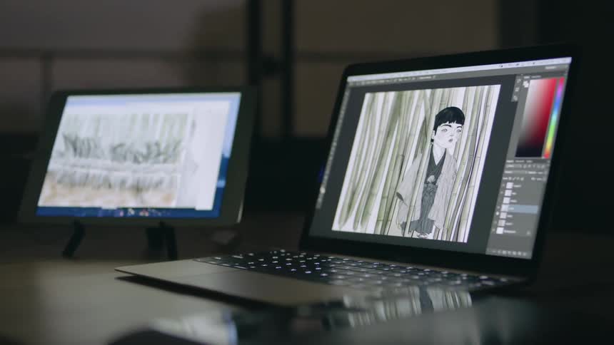 A man puts trees into a digital drawing