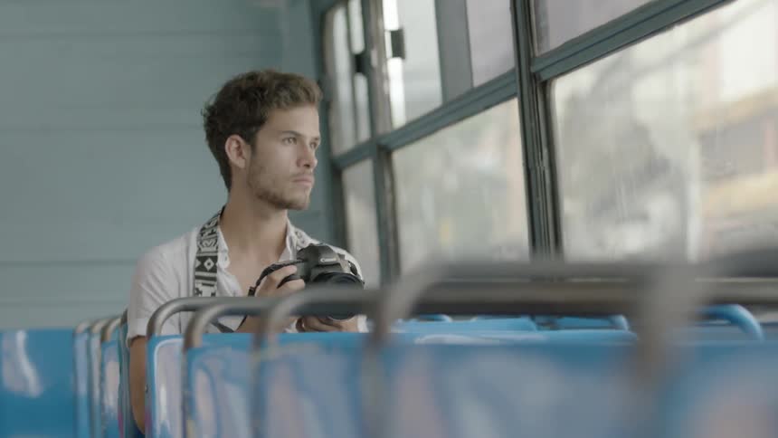 A man is taking photographs in a bus