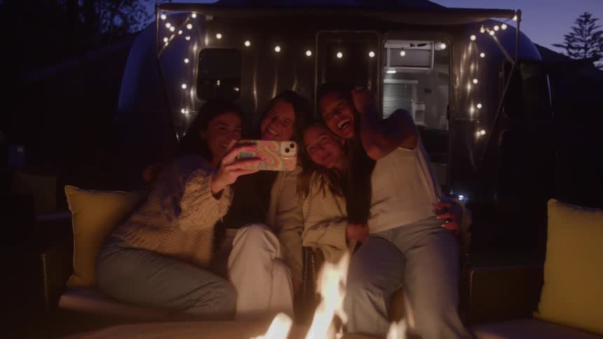 Women smile and take a selfie together