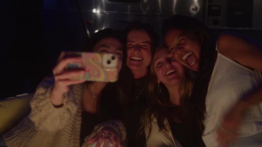 Group of friends taking a selfie at night