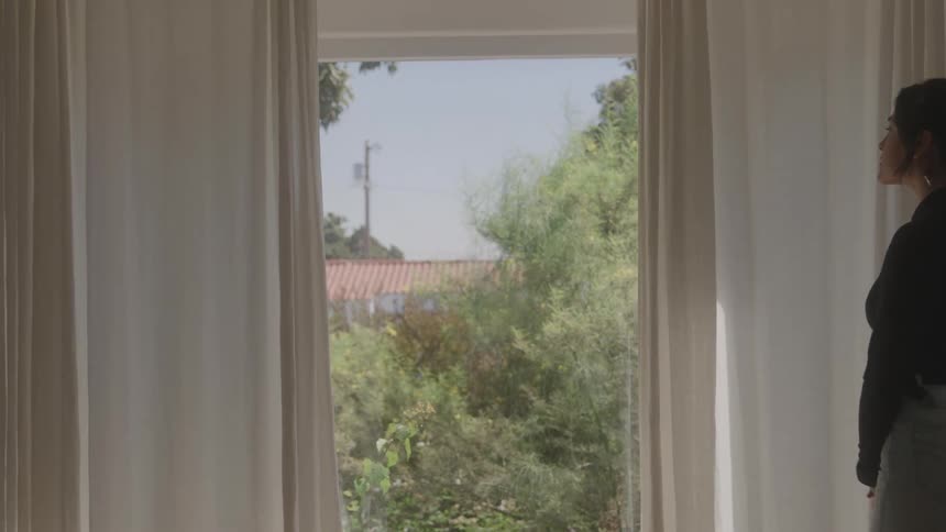 Woman walking back and forth in the room of the house
