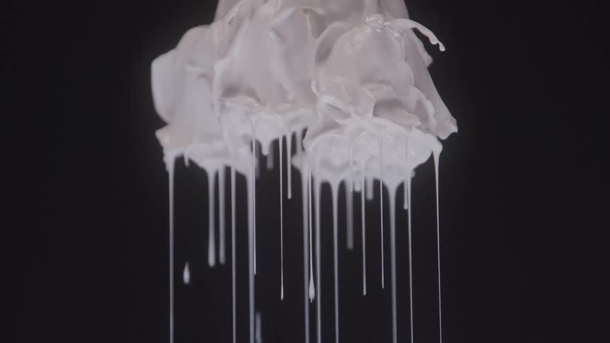 White paint dripping from an abstract object against a black background