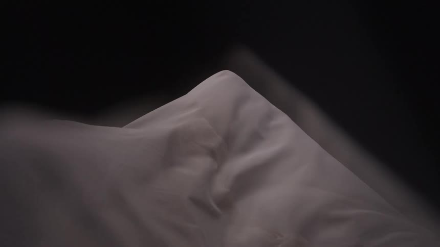 White abstract fabric in motion covering a silhouette