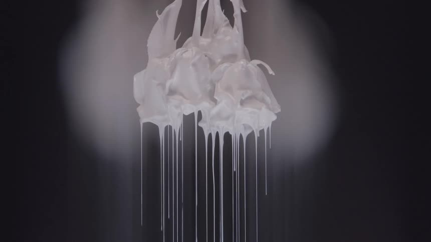 Droplets of white paint dripping from an abstract flower