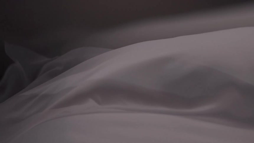 Abstract moving white curtain against a dark background