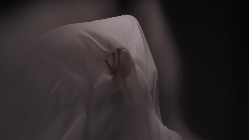 White fabric moving over an abstract person