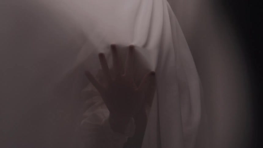 Person hand on an abstract white fabric in motion