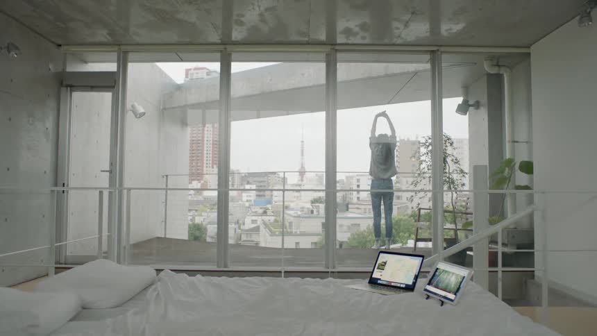 A woman is stretching out on a balcony