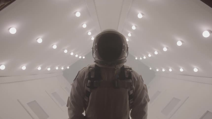 The space man stands in the hall