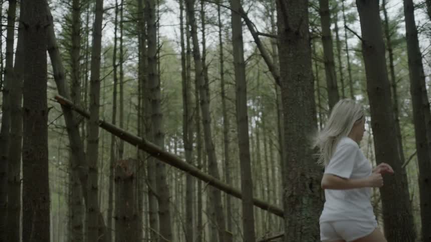 A woman running through the woods