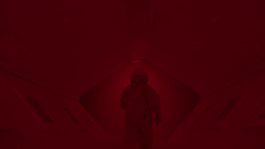 Person in spacesuit walking through a tunnel with flashing lights