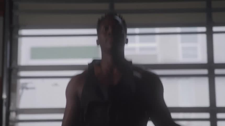 Man works out by jumping rope indoors