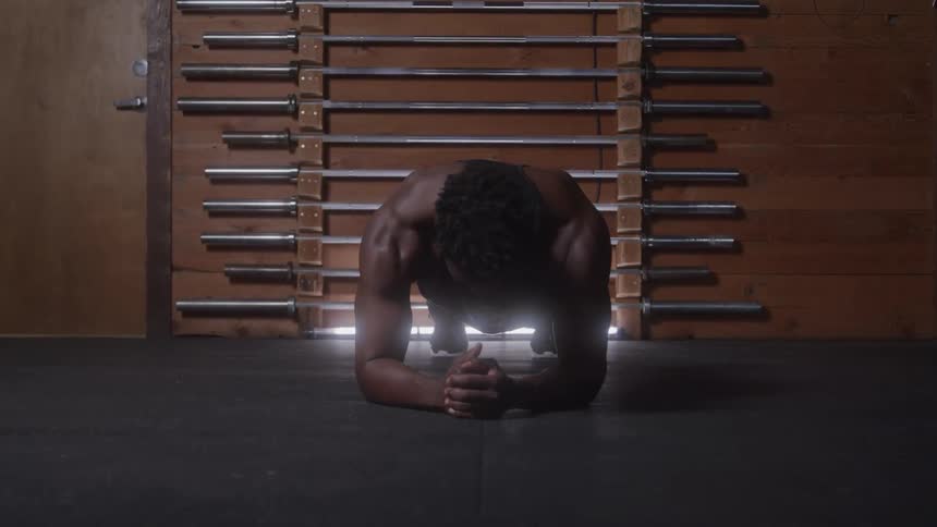 The man is stretching in the gym