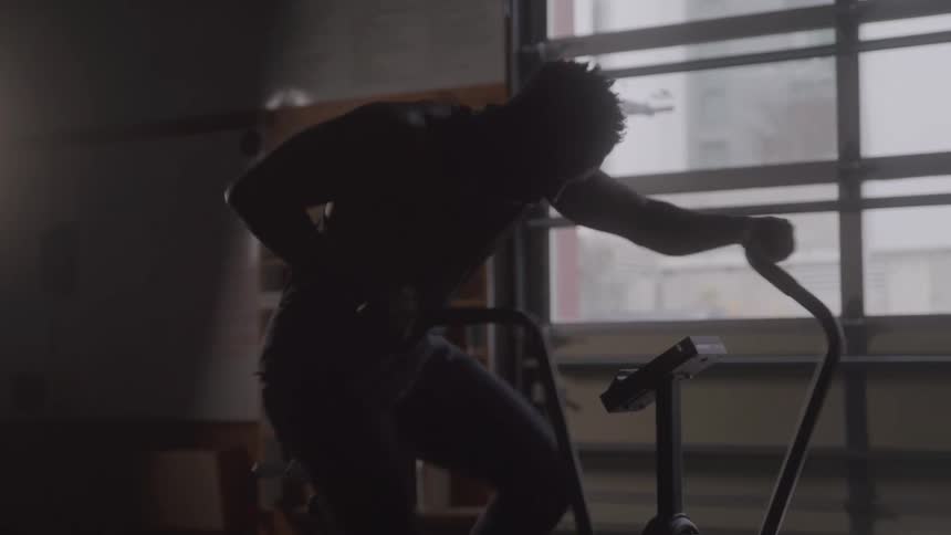 Young black man doing an intensive workout in the gym at midday