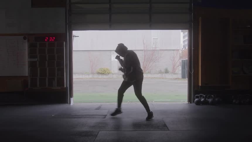 The man is shadow boxing in the gym