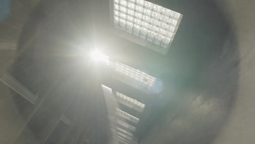 An empty warehouse with sunlight shining through windows
