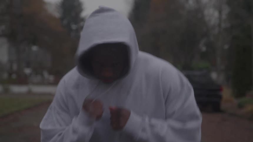 The man is running and punching on the road