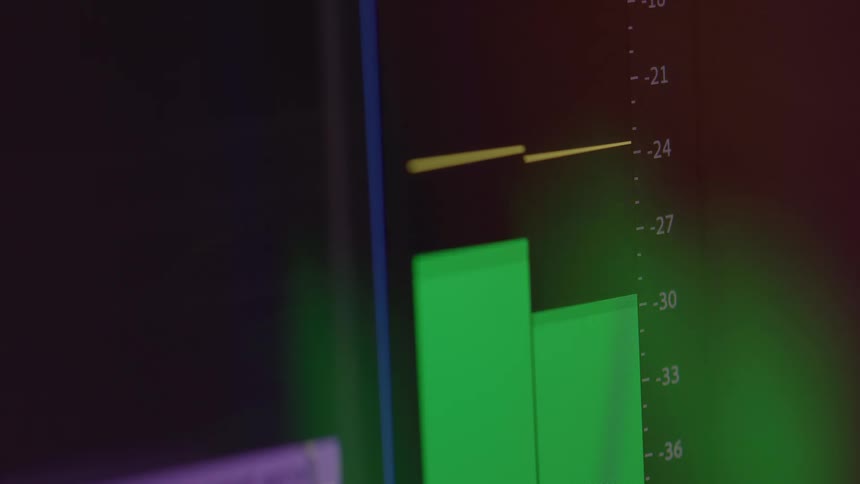 Extreme close up of a computer screen displaying two green sound decibel bars