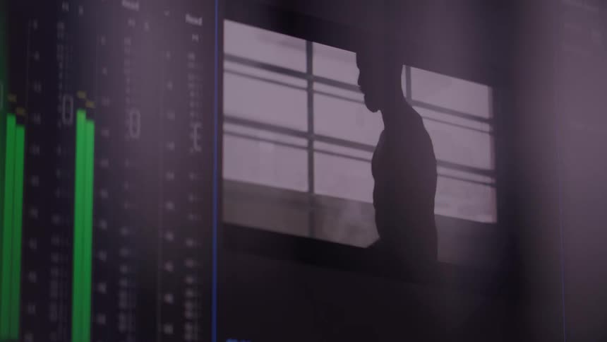 Editing screen shows audio meters next to a video playback