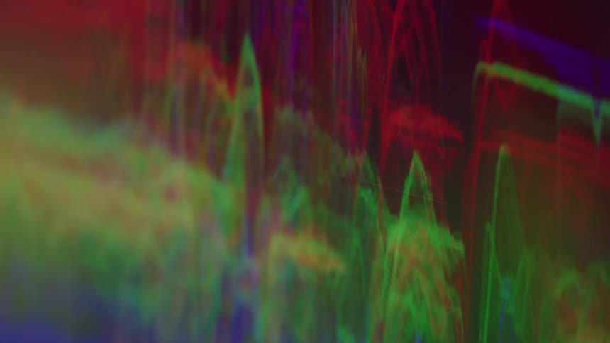 Colorful waves in shades of green red and blue forming an abstract pattern