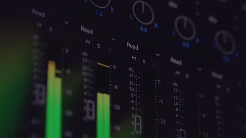 The video shows an abstract closeup shot of an audio equalizer on a computer screen multiple bars are visible glowing in different colors as they rhythmically rise and fall to indicate sound levels