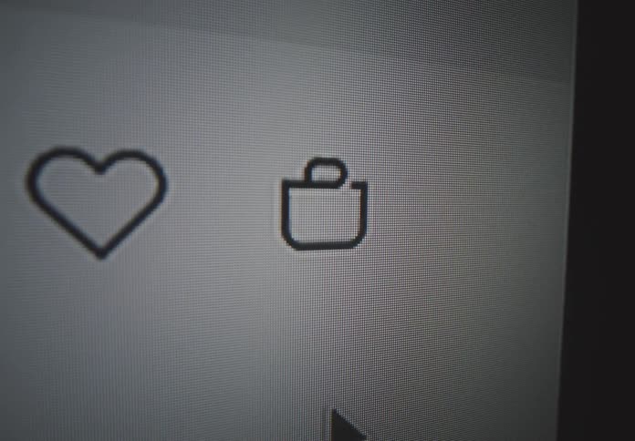 Computer cursor clicking on the cart bag icon in a shopping website