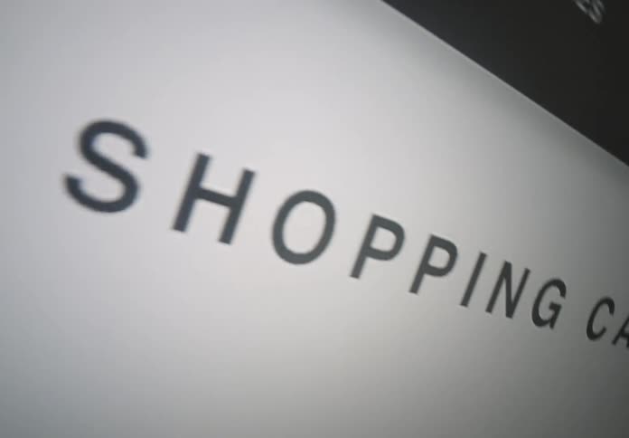 The video shows an abstract closeup shot of the words shopping cart on a computer screen the camera pans from left to right across the text