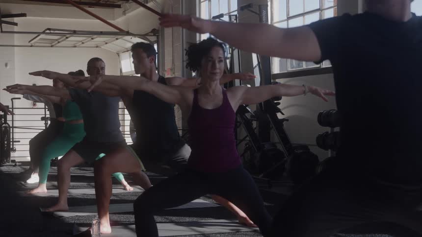 Group of young people working out in a gym at midday