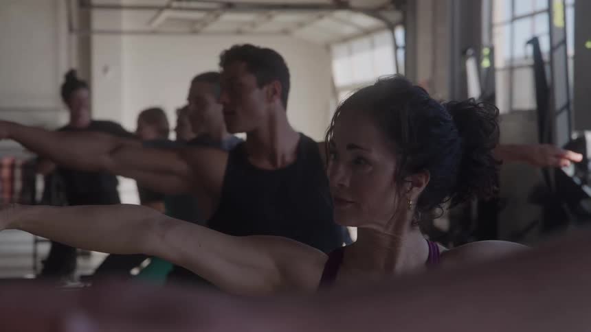 People are doing yoga together in the gym