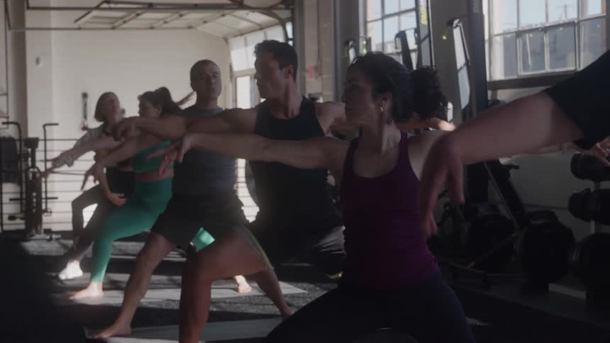 Group of people practicing yoga at the gym