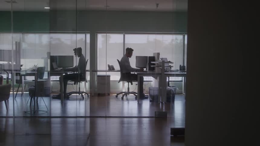 Man working sitting in front of the computer at an office desk