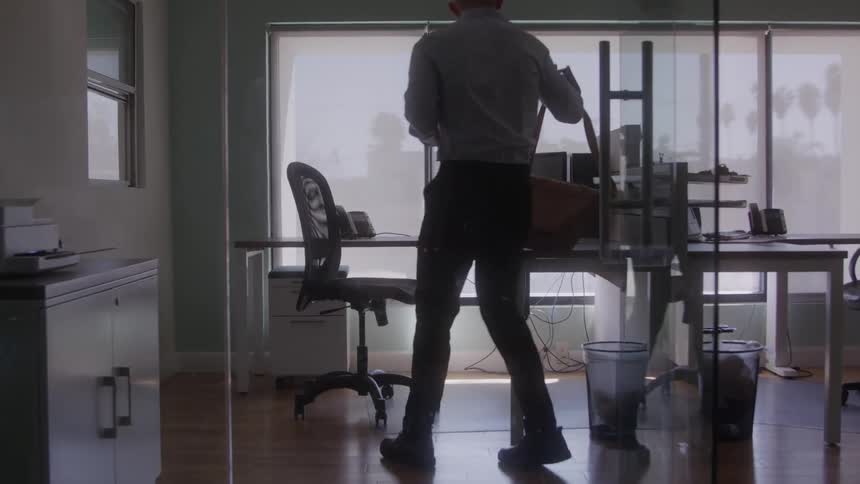 Man sitting at an office desk in a room