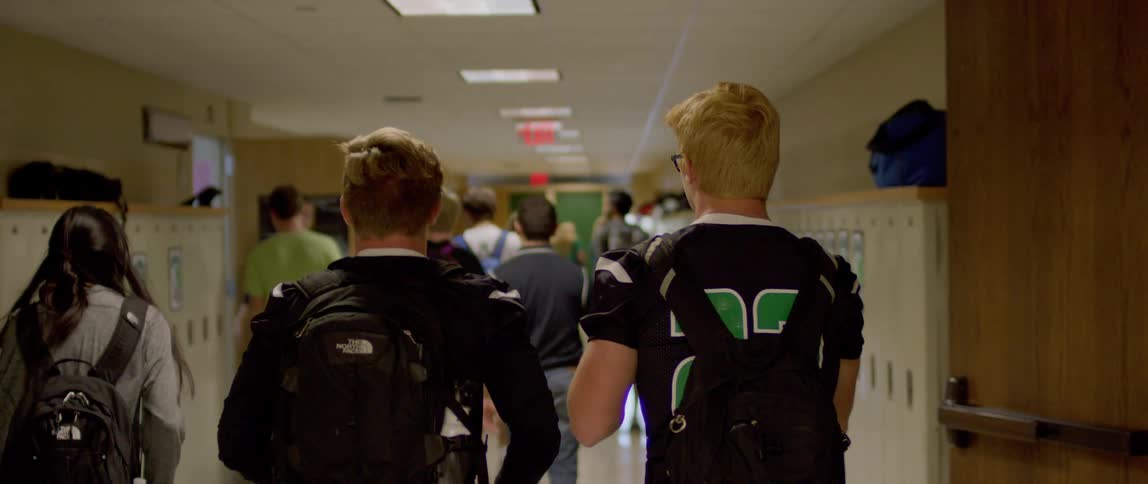 Group of students walking down a school hallway