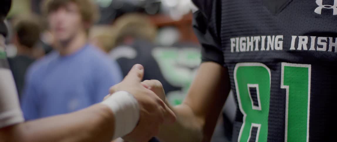 Players shake hands in the locker room
