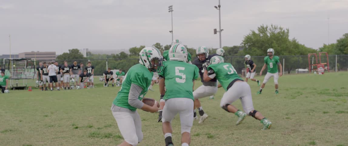 Football players are competing on the field