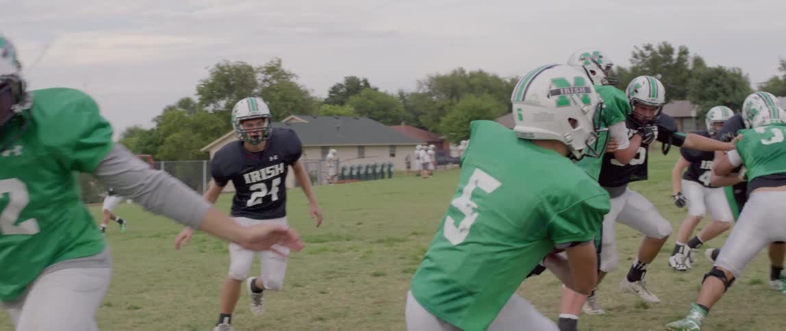 American football players in action during a practice play