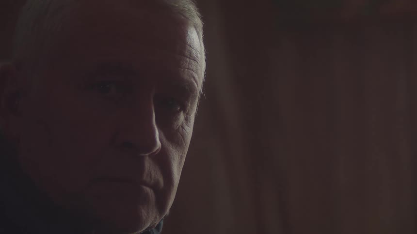 The man is looking off to the side