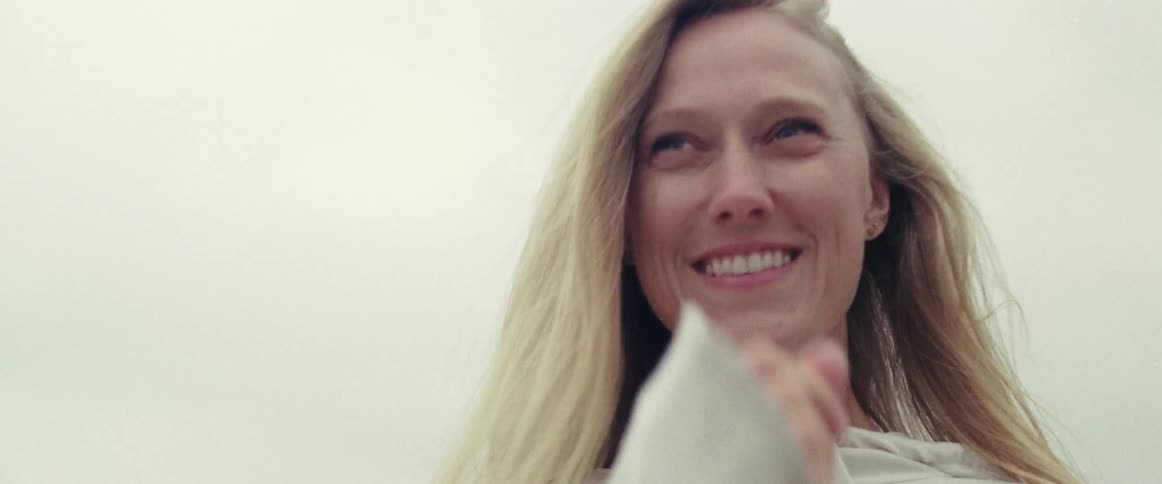 Woman smiles outside on an overcast day