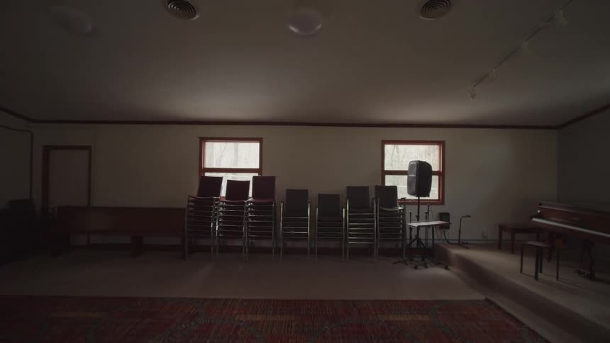 Stacked chairs and instruments arranged in a church room