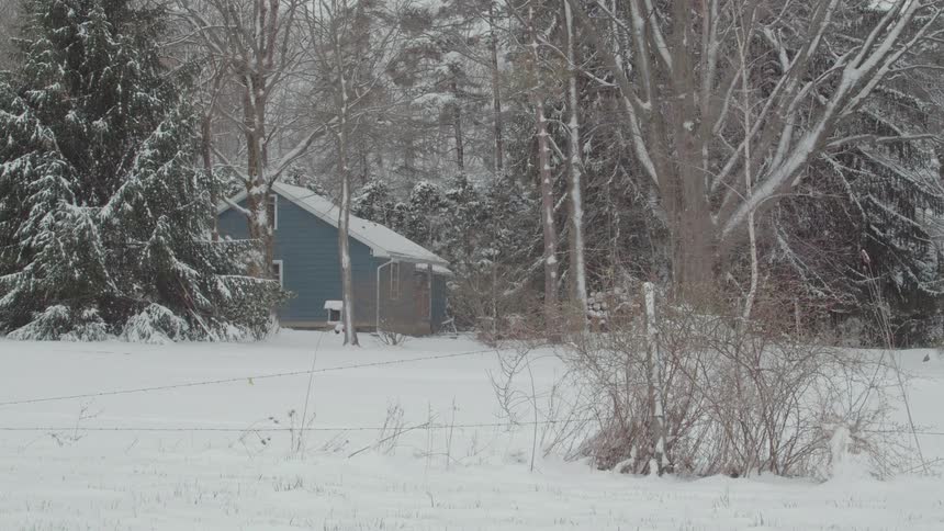 A house with a yard covered in snow