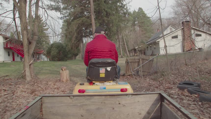Person walking with a small vehicle through the farm