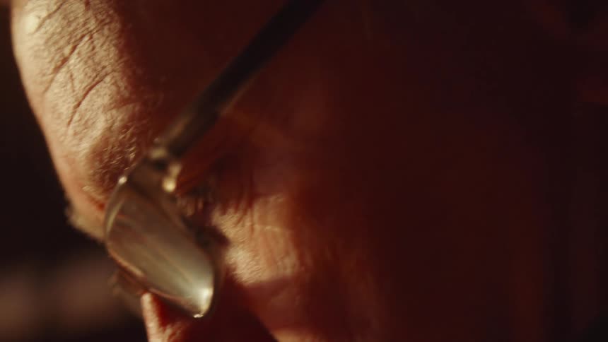 Closeup of an elderly mans face wearing glasses