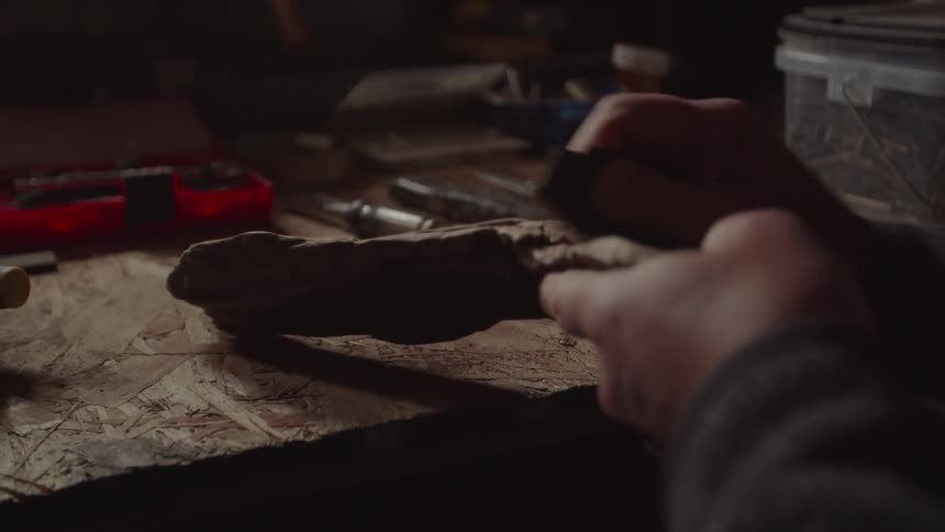 The man sands the piece of wood