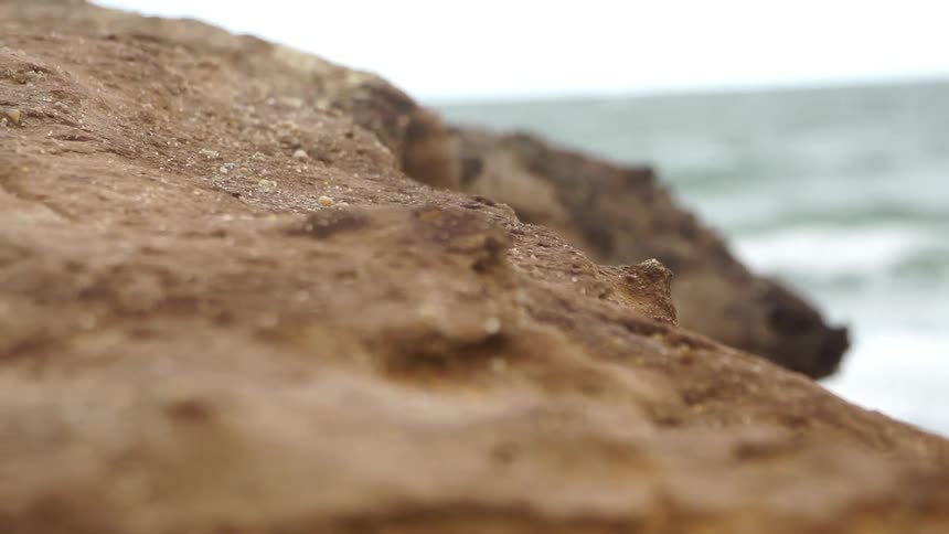 Close up view of a boulder near the ocean