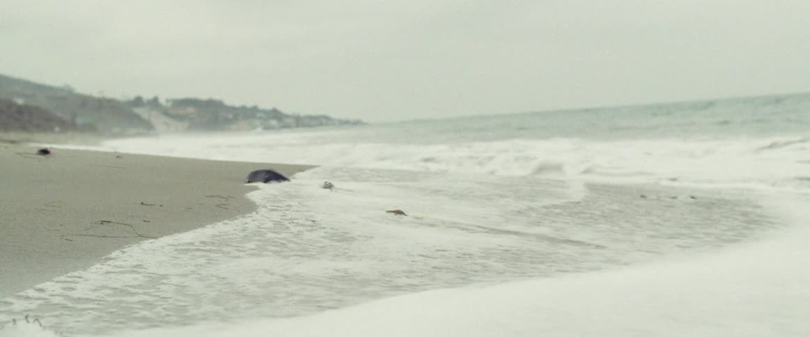 A close up view of some water rushing into shore