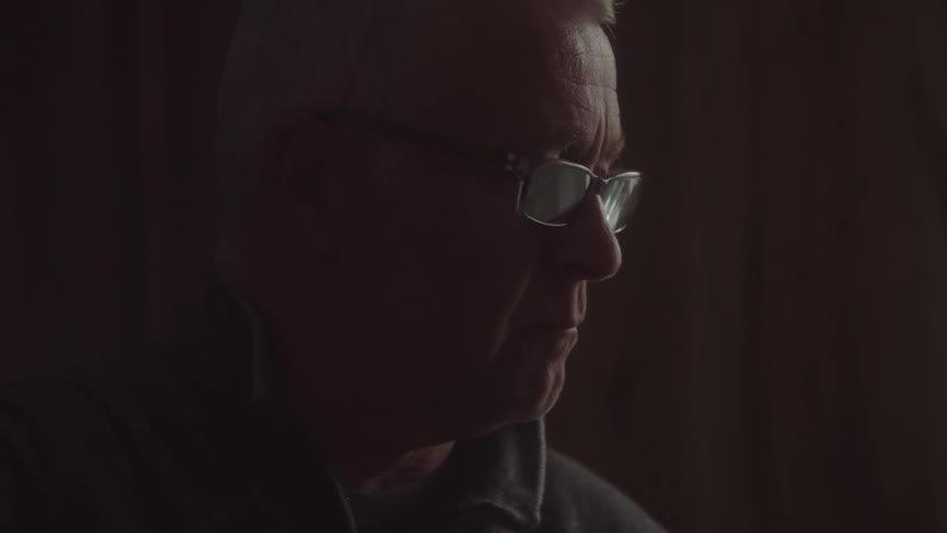 Man with glasses in a concentrated indoor space
