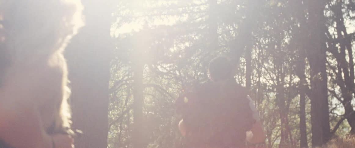 A man is hiking in the woods with a woman